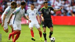 Gareth Bale runs with the ball with England players surrounding him