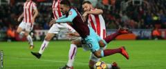 Lanzini tumbles as Stoke's Erik Pieters makes a challenge