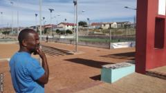 Dumi looks out at the football pitch