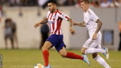 Atletico 's Angel Correa (left) being pursued by Real Madrid midfielder Toni Kroos