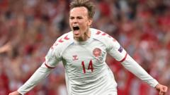 Emotional win sees Denmark through to face Wales in last 16