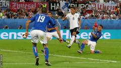 Mesut Ozil scores for Germany against Italy at Euro 2016