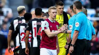 Burnley and Newcastle shake hands before their Premier League match