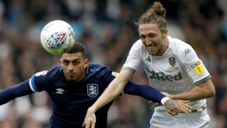 Huddersfield and Leeds players battle for the ball