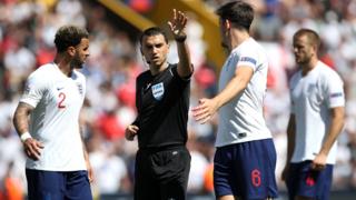 Kyle Walker and Harry McGuire quiz the referee