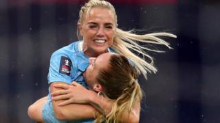 Alex Greenwood (top) celebrates with Sam Mewis
