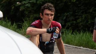 Geraint Thomas being treated by a medic after crashing