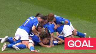 Italy teammates celebrate winning goal.