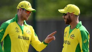 Australia batsman Steve Smith (left) talks to David Warner (right) during a World Cup warm-up match