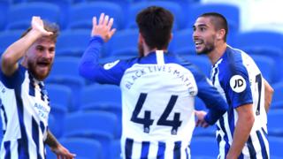 Brighton's players celebrate scoring against Arsenal