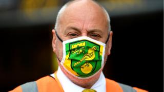 Norwich City security guard with a club mask on