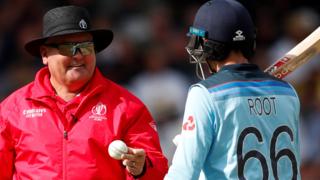 Umpire Marais Erasmus with England's Joe Root