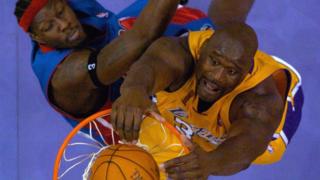 LA Laker's Shaquille O'Neal dunks over Detroit Pistons' centre Ben Wallace