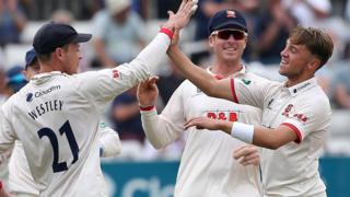 Essex bowler Adam Beard (right) celebrates taking a wicket against Somerset