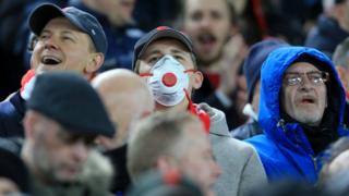 A Liverpool fan wears a face mask at the Champions League match v Atletico MAdrid on 11 March