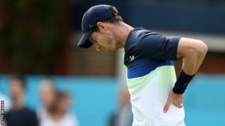 Andy Murray holds his back in pain