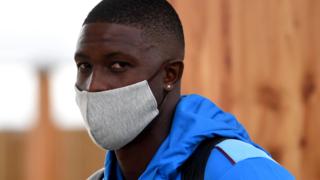 West Indies captain Jason Holder wears a face mask as he arrives at Manchester Airport for his side's Test tour of England