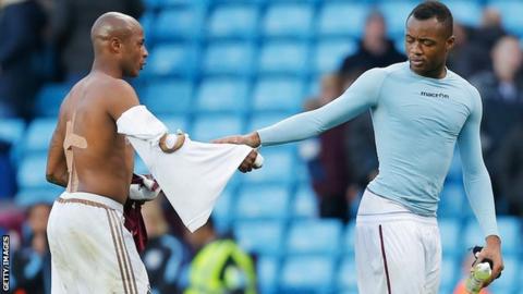 Brothers Andre and Jordan Ayew shake hands after a game between Swansea and Aston Villa
