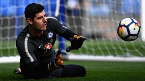 Thibaut Courtois makes a save during a warm-up session