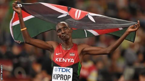 Kenya's Asbel Kiprop celebrates by raising the Kenyan flag after winning gold in the men's 1500m final at the 2015 World Championships