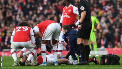 Arsenal players comfort Calum Chambers