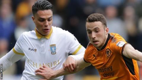 Diogo Jose Teixeira da Silva of Wolverhampton Wanderers is challenged by Joey Pelupessy of Sheffield Wednesday