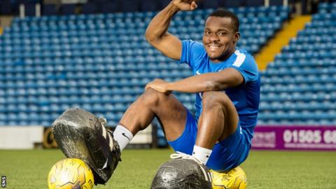 Souleymane Coulibaly poses for photos at Rugby Park