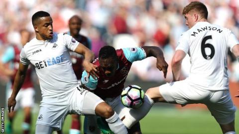 Martin Olsson and Alfie Mawson in action against West Ham's Michail Antonio