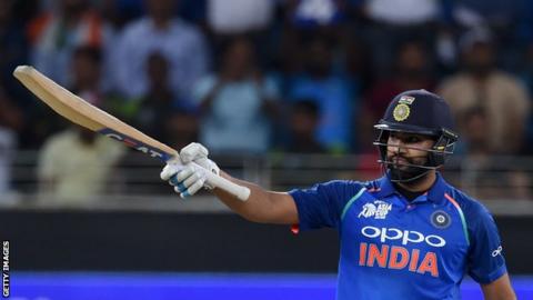 India captain Rohit Sharma raises his bat to salute the crowd after hitting fifty against Pakistan