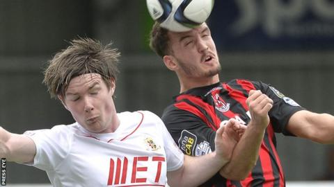 Portadown's Peter McMahon in action against Josh Robinson of Crusaders