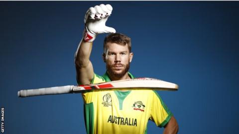 David Warner drops his bat in a photo session