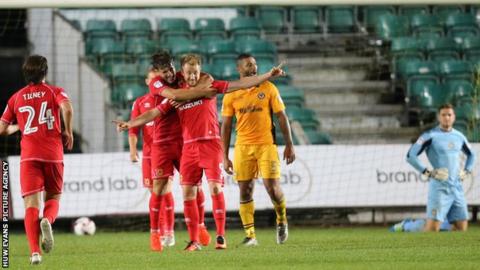 Dean Bowditch of MK Dons celebrates with team mates after he scores the winner in added time