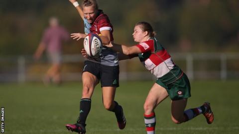 Emily Scott of Harlequins Ladies chips the ball forward during her team's victory over Firwood Waterloo