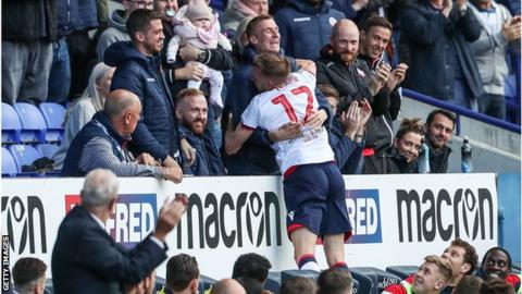 Bolton Wanderers' Craig Noone celebrates scoring his side's first goal with former team mate Stephen Darby