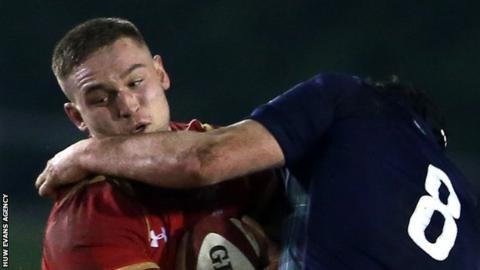 Harrison Keddie is tackled by Matt Smith of Scotland U20