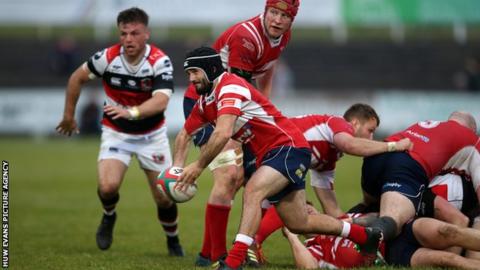 Llanelli scrum-half Gareth George gets the ball away against Pontypool