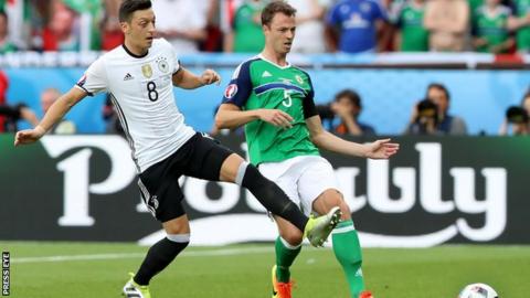 Jonny Evans battles with Germany's Mesut Ozil in the game at Euro 2016