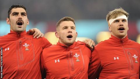 Cory Hill, Elliott Dee and Aaron Wainwright singing the Wales national anthem before an international match in 2018