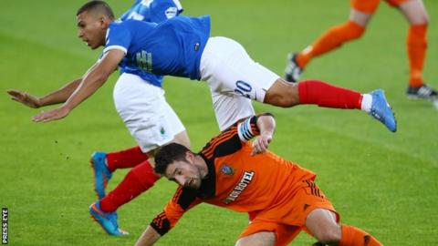 Linfield's TJ Murray is challenged by William Beckett of Glebe Rangers