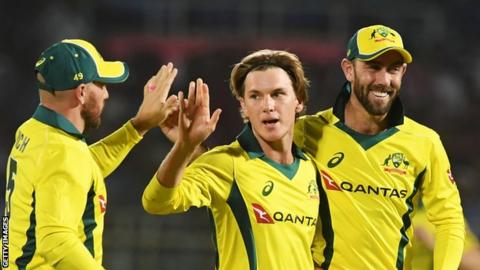 Adam Zampa (centre) took the wicket of India captain Virat Kohli before Glenn Maxwell (right) made 56 for Australia