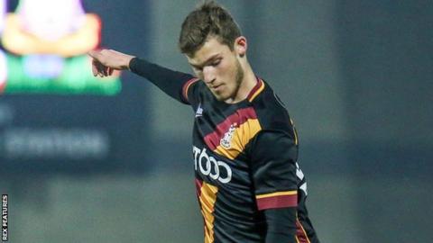 Bradford City winger Ellis Hudson looks down at the ball during an EFL Trophy game against Morecambe