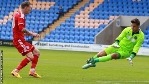 Joe Mason (L) of Cardiff City and Shrewsbury Town goalkeeper Jayson Leutwiler