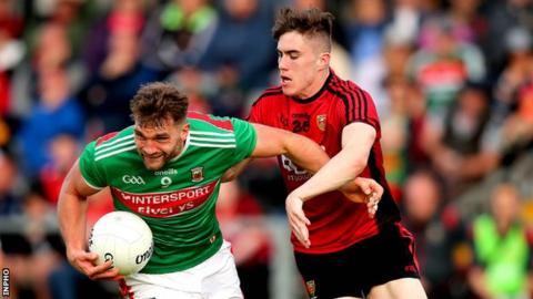 Aidan O'Shea of Mayo attempts to shrug off the challenge of Owen McCabe