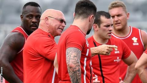 John kear, surrounded by Wales players, makes a point to his squad during a training session