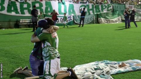 Fans cry while paying tribute to the players of the Brazilian team Chapecoense