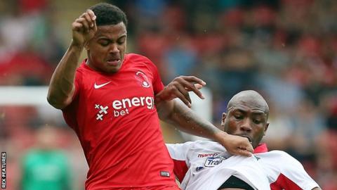 Leyton Orient's Josh Koroma and Wrexham's Manny Smith battle for the ball