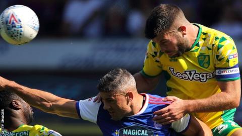 Grant Hanley climbs above Jon Walters to win a header in the East Anglia derby