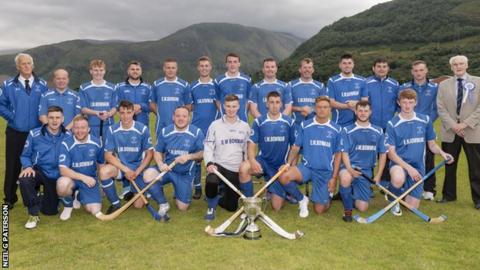 Kilmallie players and coaches celebrate with the Balliemore Cup