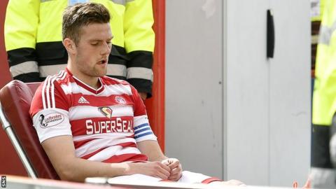 Hamilton Accies' Michael Devlin is helped off the park against Dundee