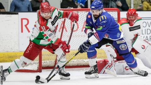 Bryce Reddick (L) battles for the puck